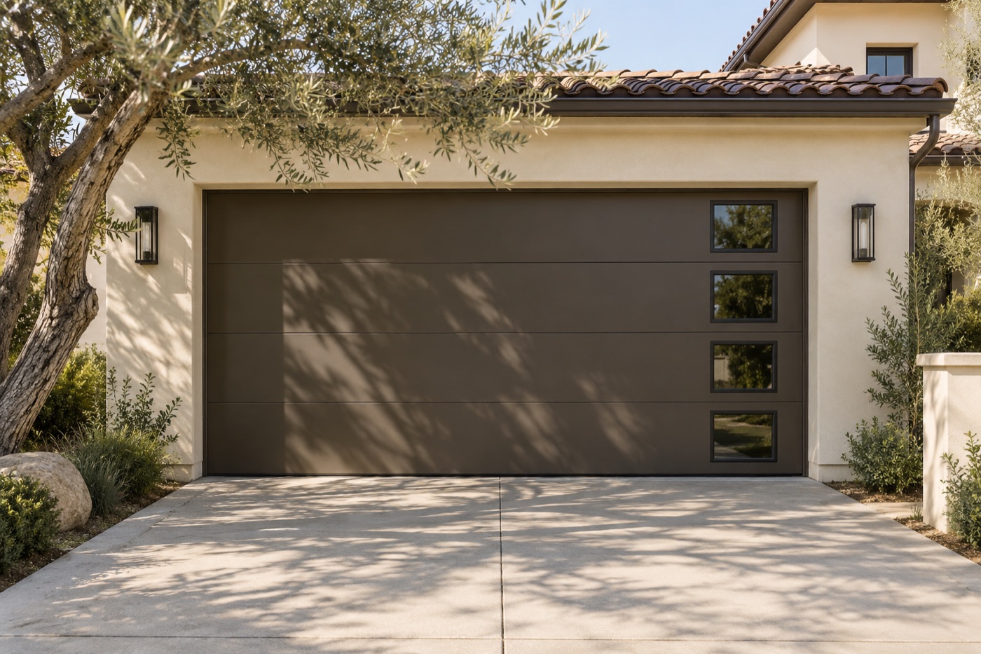 Dark bronze flush garage door with vertical windows on a cream home
